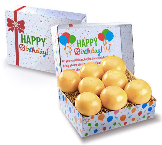 White grapefruit pictured in a gift box printed with Happy Birthday.