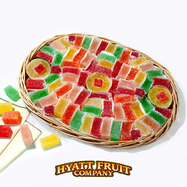 Colorful gummy candy in a wicker jellies gift basket with Hyatt Fruit Company logo.